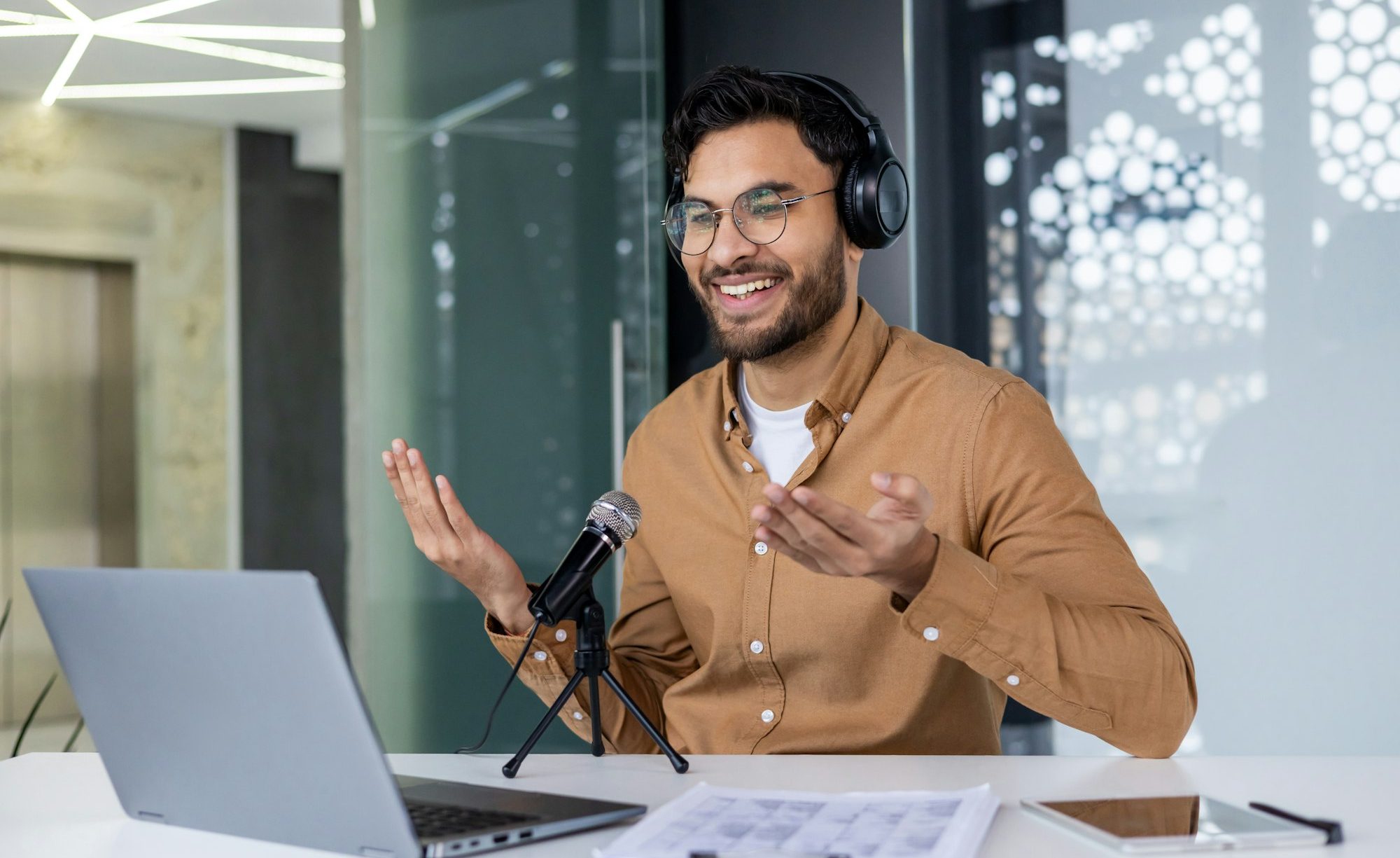 Hindu business trainer uses professional microphone to record online video webinar course, man